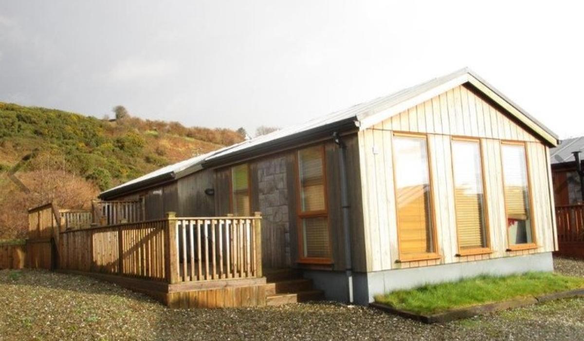 WATCH: This affordable shoreside log cabin is a refreshing spin on the usual holiday park home [Video]