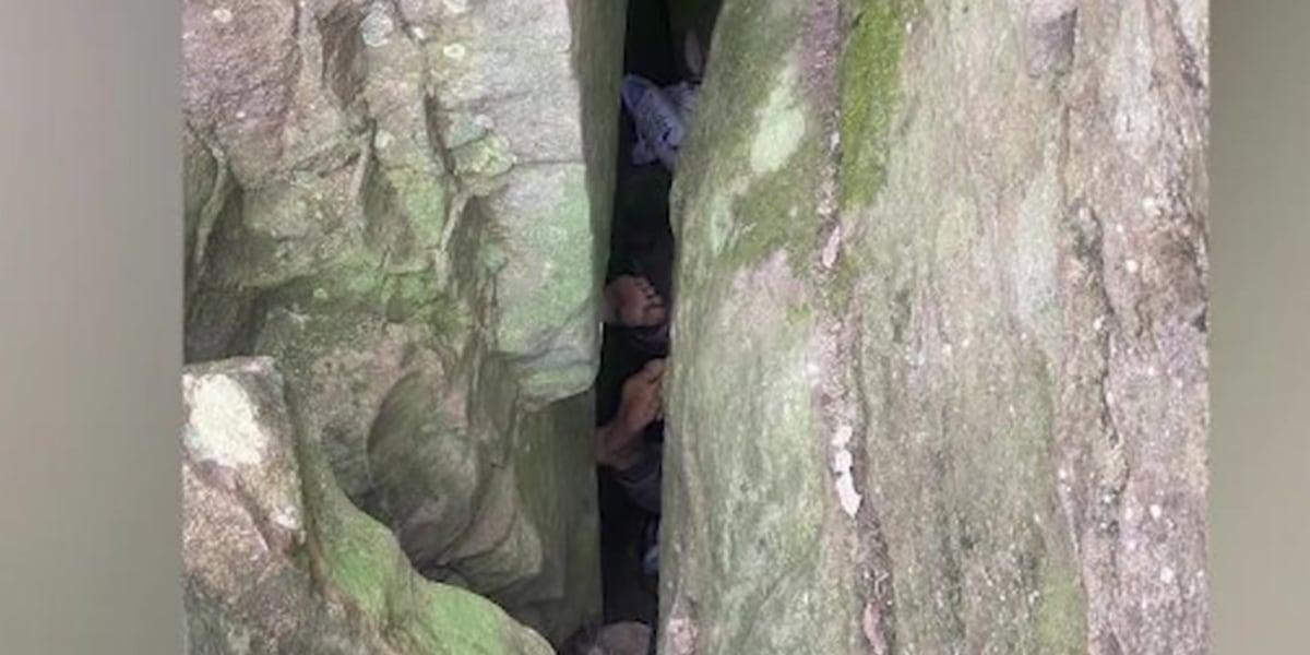 Woman stuck 7 hours upside-down between rocks after trying to retrieve phone [Video]